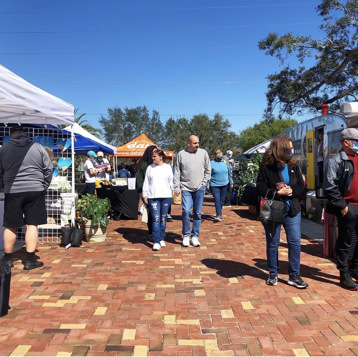 The Winthrop Pop Up Market winds down the tree-lined main street of Winthrop Town Centre with the Times Building in the background.